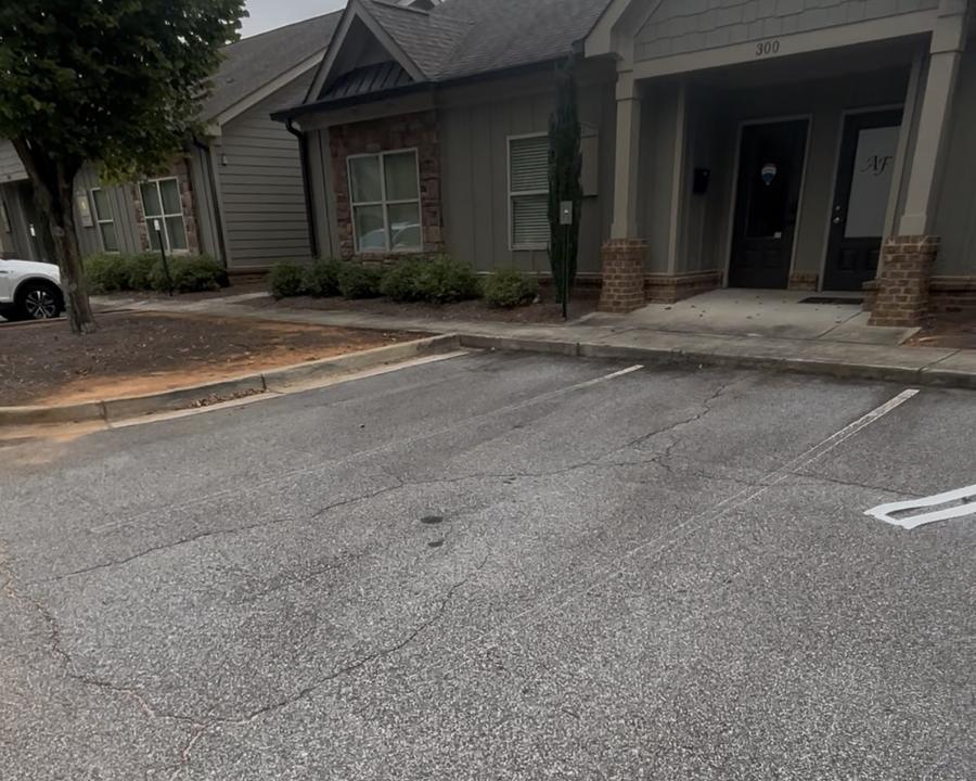 A parking lot with worn, barely visible stall lines
